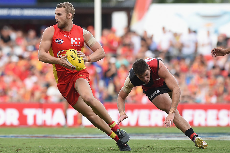 AFL 2016 Rd 01 - Gold Coast v Essendon GOLD COAST, AUSTRALIA - MARCH 26: Trent McKenzie of the Suns runs with the ball during the 2016 AFL Round 01 match between the Gold Coast Suns and the Essendon Bombers at Metricon Stadium, Gold Coast on March 26, 2016. (Photo by Matt Roberts/AFL Media)